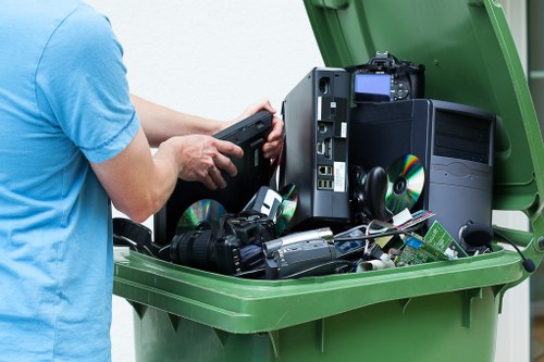 Workers wearing PPE and handling commercial waste at a depot